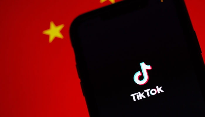 TikTok Logo auf Smartphone vor China-Flagge