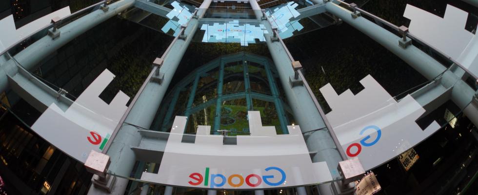 Google-Logos gespiegelt auf Glaswänden, rund