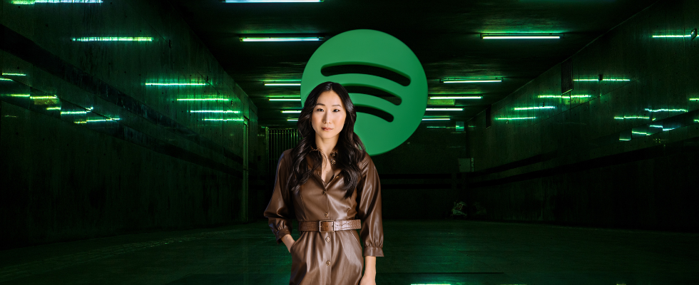 Saruul Krause-Jentsch in front of the Spotify logo in a brown coat