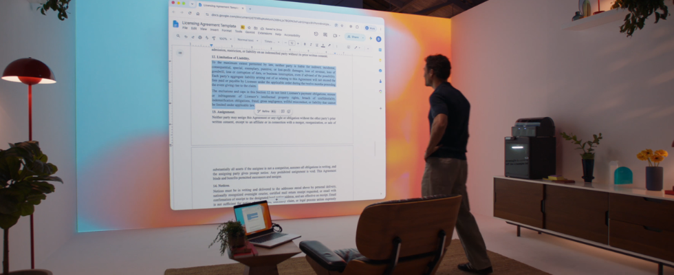 Mann steht vor Leinwand mit digitalem Interface, Laptop mit GPT-6 Astra dahinter
